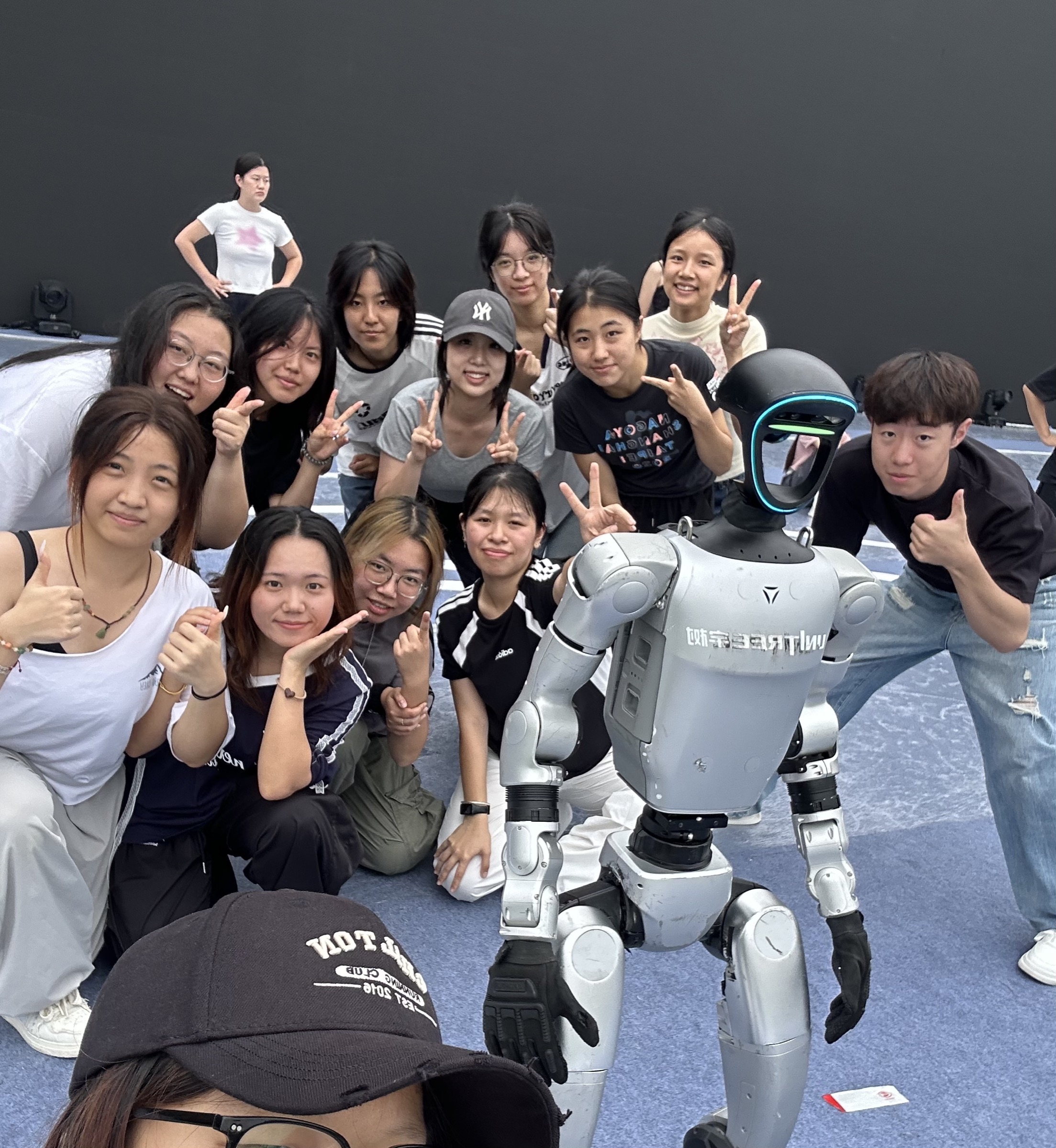 街舞社成员与人形机器人在排练现场的合影